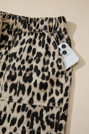 Denim shorts with leopard print, drawstring waist, and a phone in the pocket.