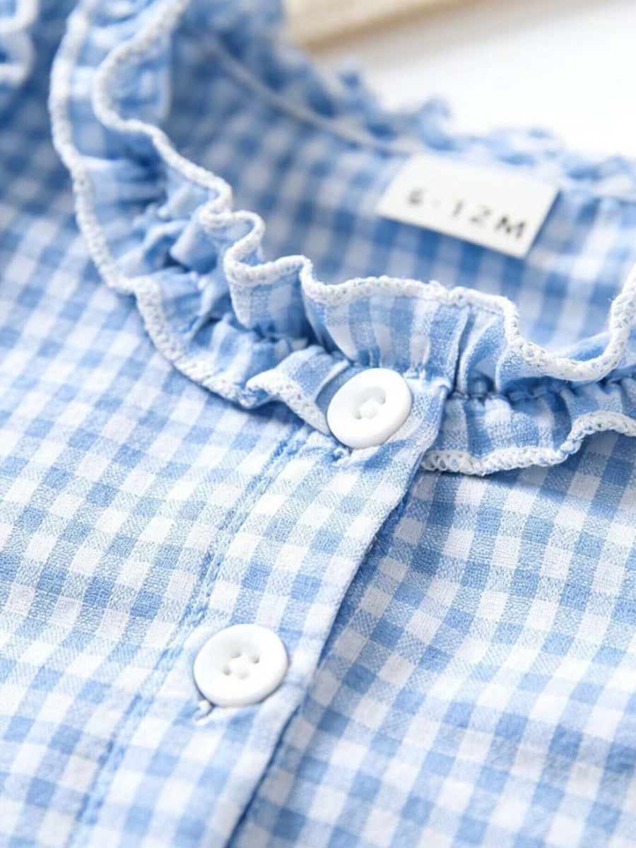 Baby dress in pastel blue gingham with white ruffled neckline and button front.