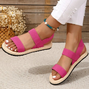 Hot Pink rope-sole cross-strap sandals with elastic straps and espadrille sole.
