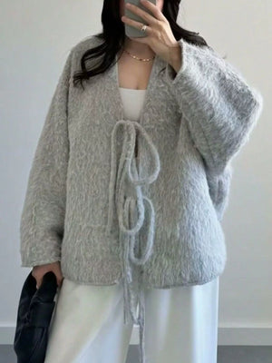 Textured knit tie-front cardigan in silver gray with fuzzy material and open front.