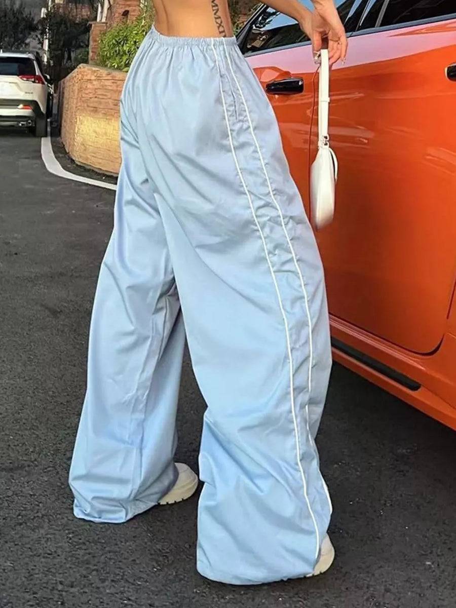 Light blue wide-leg maternity trousers with gathered waistband and white piping detail.
