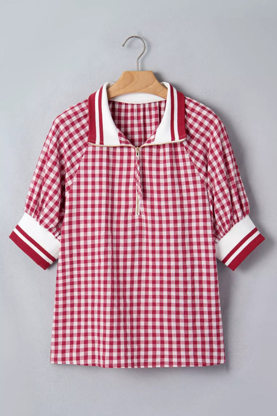 Red gingham cotton blend shirt with puff sleeves, zip collar, and striped cuffs.