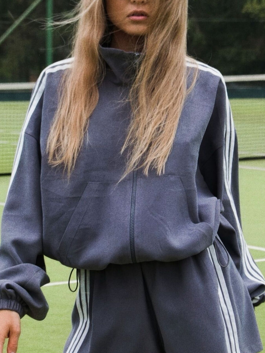 Black track jacket with cropped and half-zip