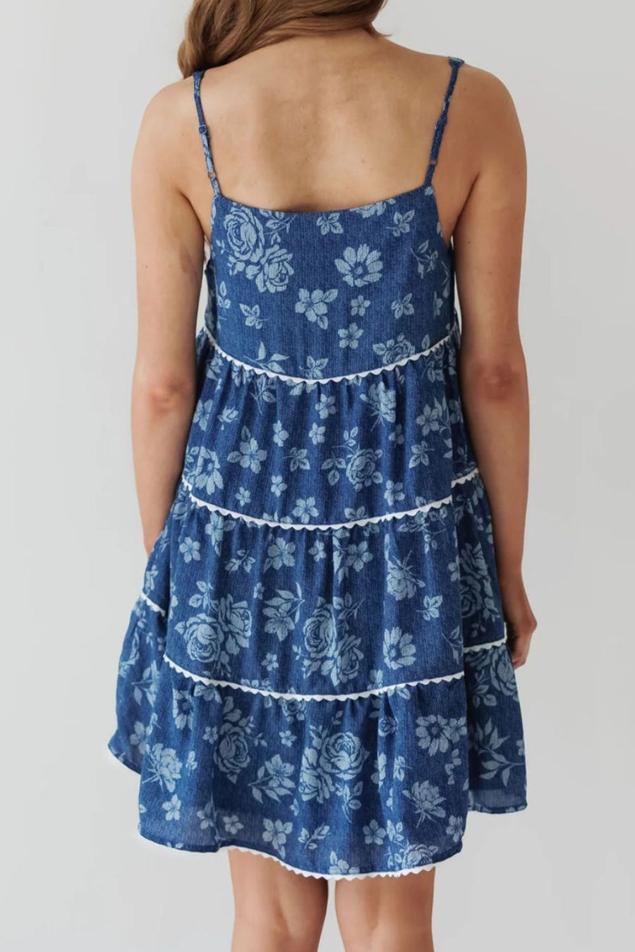 Floral denim sundress in medium with tiered skirt and white trim.
