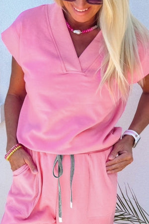 Pink cotton casual drawstring top and pants set with V-neck and short sleeves.
