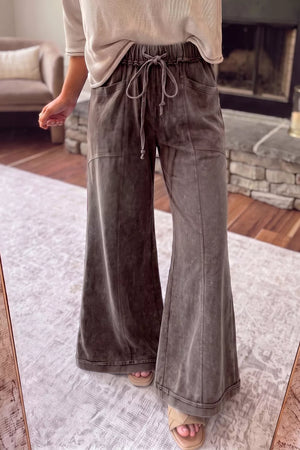 wide-leg pants in charcoal featuring drawstring waist and flared fit