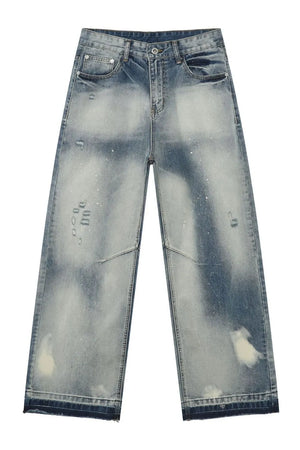Distressed painterly wide-leg jeans in medium wash denim with paint splatters and ripped details.