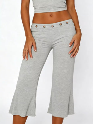 Light gray flared hem capri pants with button detail at the waist