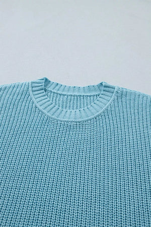 Relaxed ribbed knit sweater top in light blue with crew neck and textured cotton fabric.