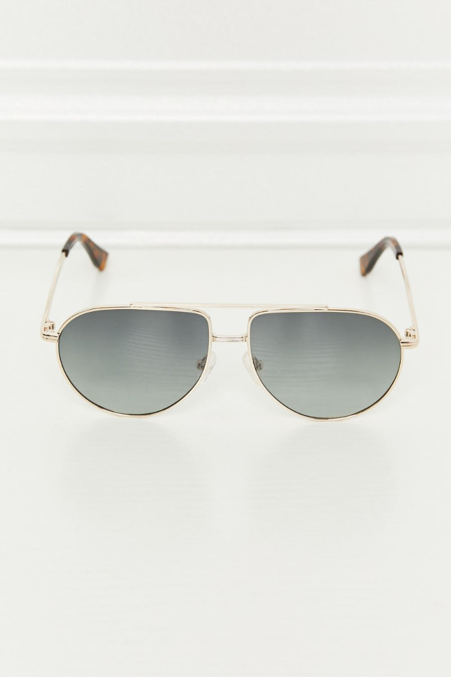 Gradient lens aviator sunglasses with a gold metal frame and tortoise shell temple tips.