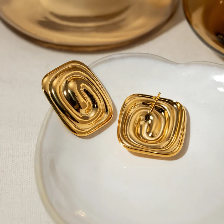 Gold sculpted swirl square earrings with a contemporary, chic design.