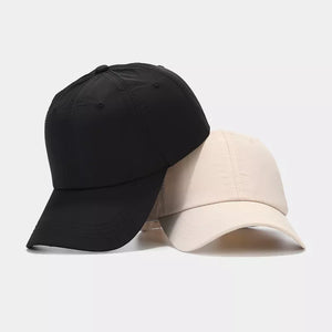 cap in black featuring adjustable strap and fitted fit