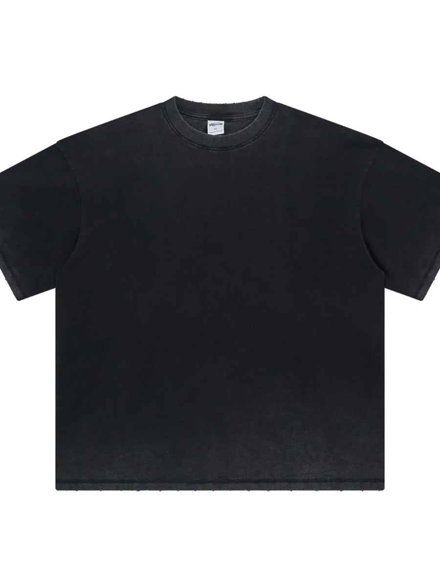 Washed black oversized t-shirt with a crewneck and raw hem details.