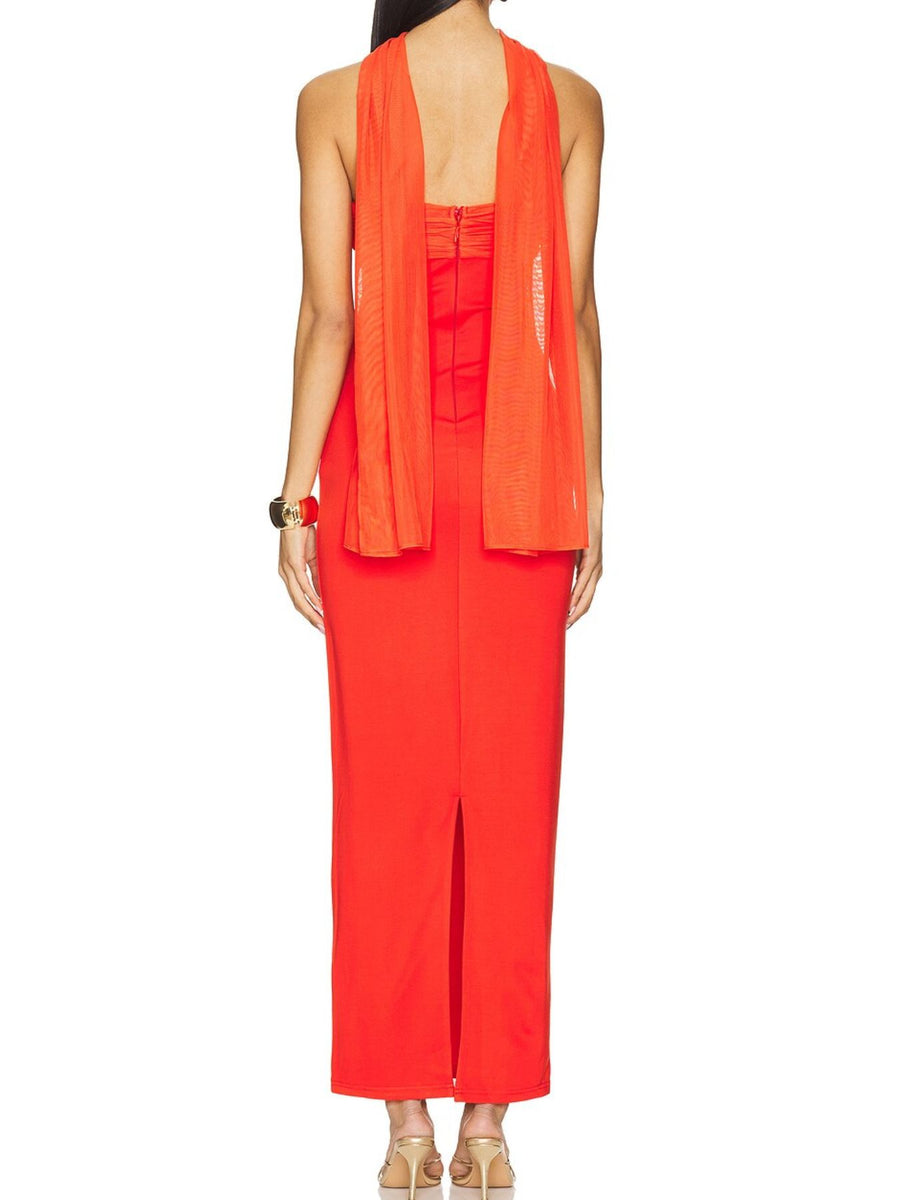 Red ruched strapless maxi dress with a sheer overlay and a side slit.