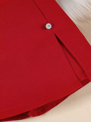 Red skirtini with asymmetrical hem and rhinestone button detail.