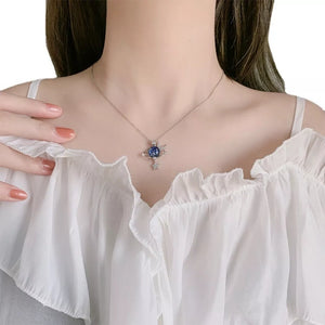 navy blue necklace featuring planet pendant and celestial motif
