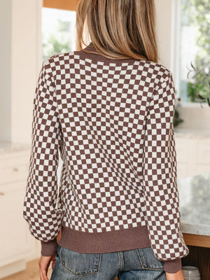 cream pullover sweater featuring buttoned and checkerboard