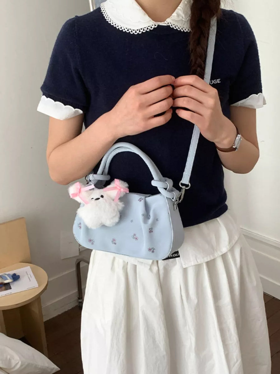 crossbody bag in light blue featuring ruched and structured fit