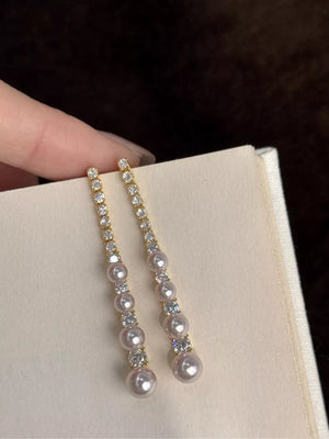 earrings in clear with drop design and below-earlobe