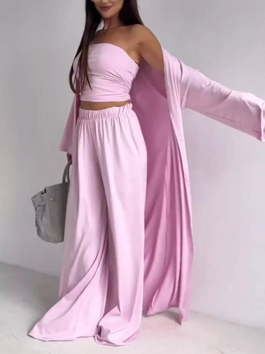 Blush pink three-piece maternity set with ruched bandeau top, wide-leg pants, and long cardigan.