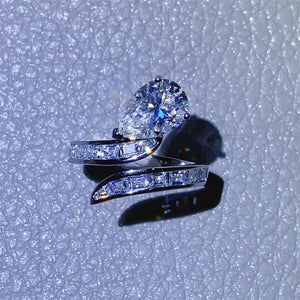 Silver bypass ring with pear cut diamond and baguette accents