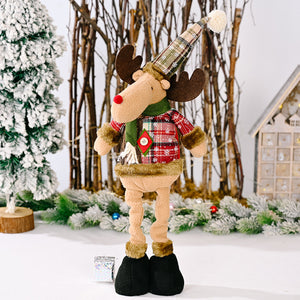 Reindeer Christmas decoration with plaid hat and sweater, green scarf, red nose.