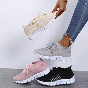 Knit runner sneakers in pink, black, gray, and beige with ribbed lace-up detail.