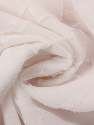 White sheer blouse with floral embroidery and frayed hem detail