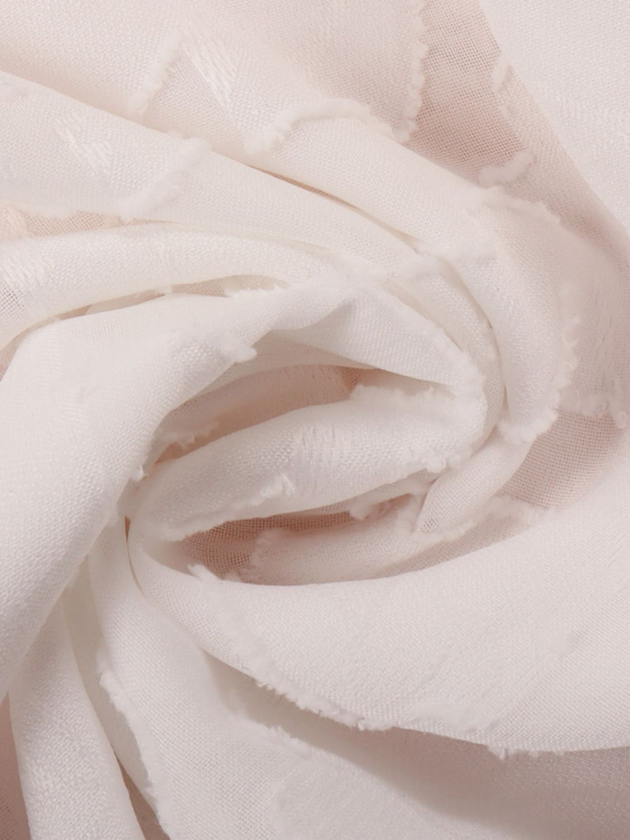 White sheer blouse with floral embroidery and frayed hem detail