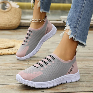Ribbed knit slip-on sneakers in gray and dusty pink with black stripe detail.