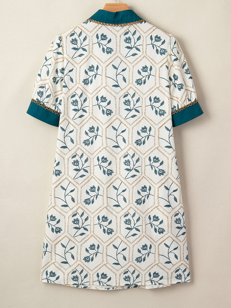 Floral print polo collar mini dress with teal trim and gold chain detail