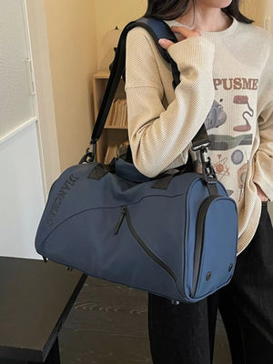 Spacious blue Oxford travel bag with padded strap and zippered pockets.