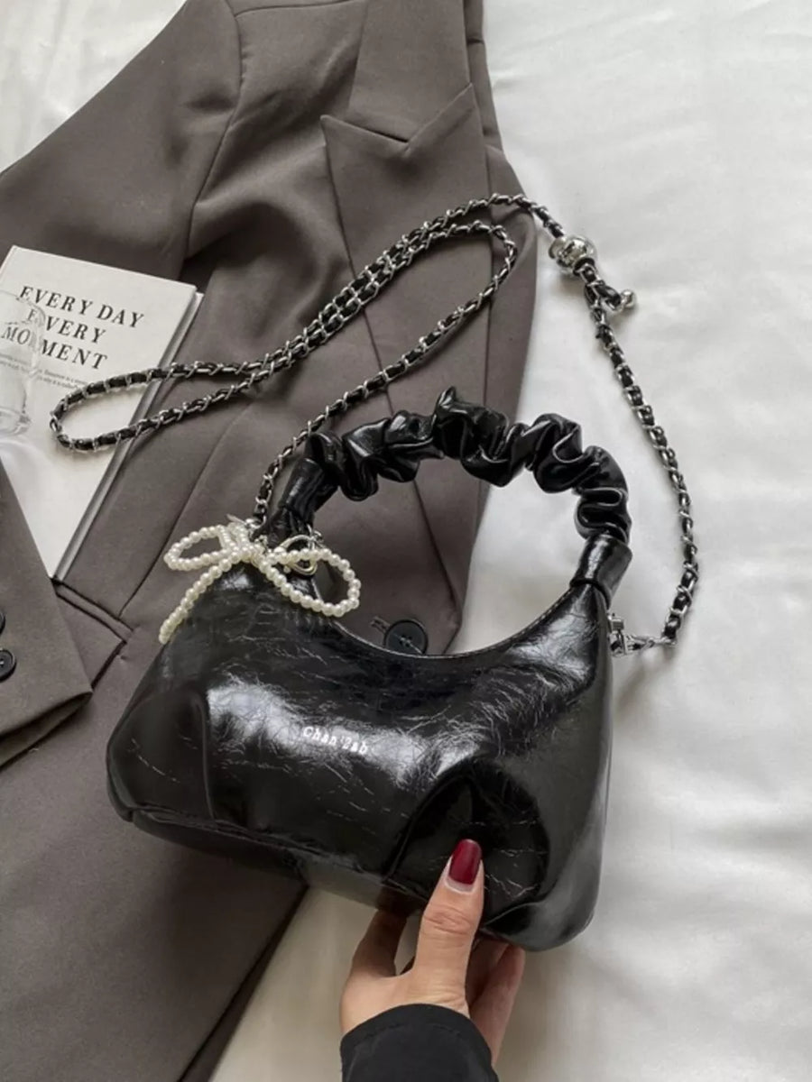 Black ruched mini crossbody bag with pearl pendant and chain strap