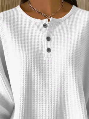 White waffle knit top with button detail and crew neck.