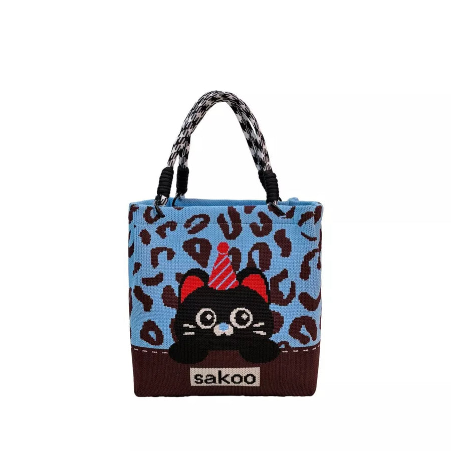 Cartoon graphic tote handbag in blue with leopard print and black cat design.