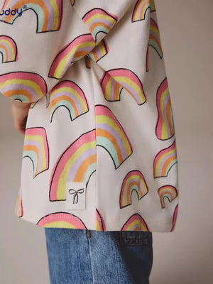 Toddler t-shirt with pastel rainbow print, cotton, crewneck, and bow detail tag.