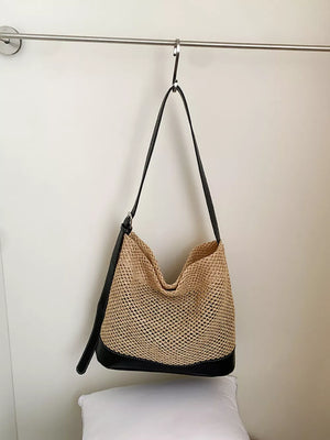 black shoulder bag featuring woven texture and woven