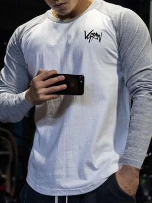 Raglan sleeve graphic tee in white with gray sleeves and black logo.