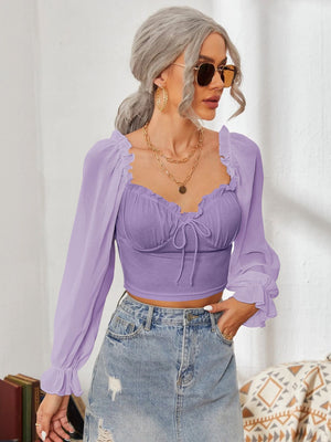 Purple bustier sleeve blouse with sweetheart neckline and tie front, ruffled cuffs