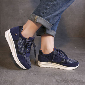Blue lace-up sneakers with rhinestone embellishments and a chunky sole.
