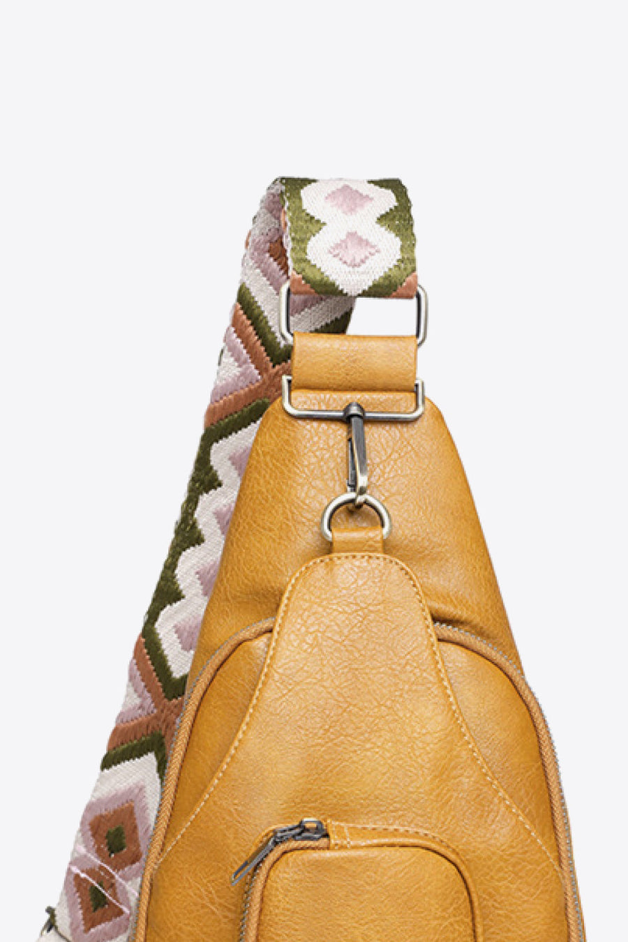 Honey PU sling bag with a patterned strap and silver hardware.