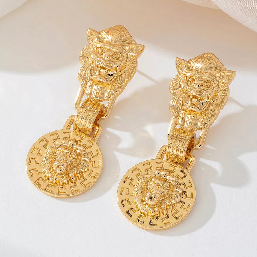 Gold earrings featuring drop and animal-print