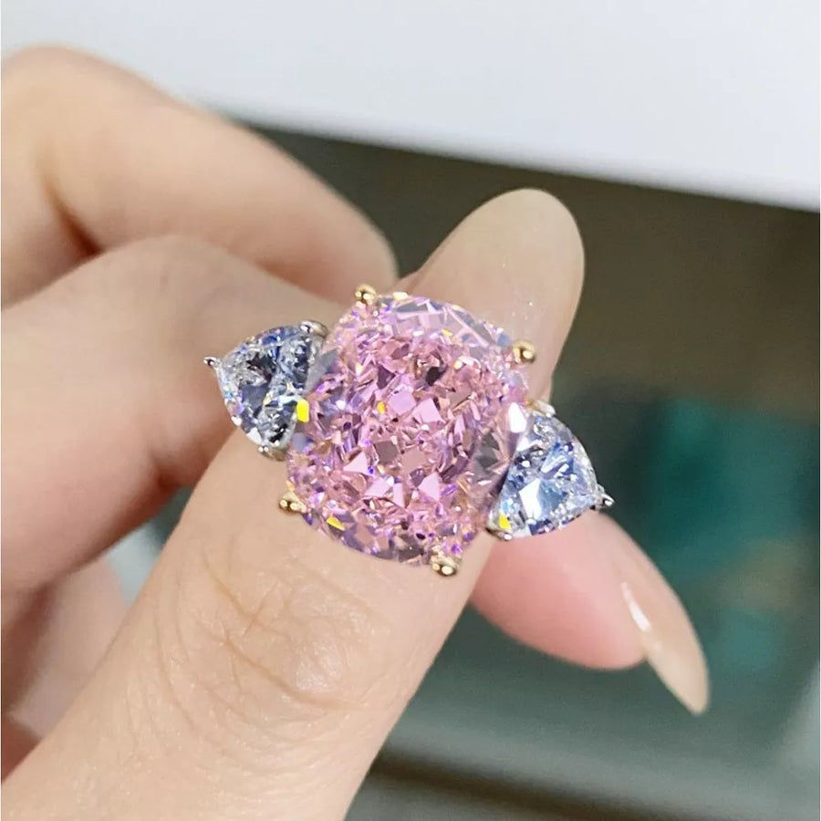 clear ring featuring three-stone setting and geometric