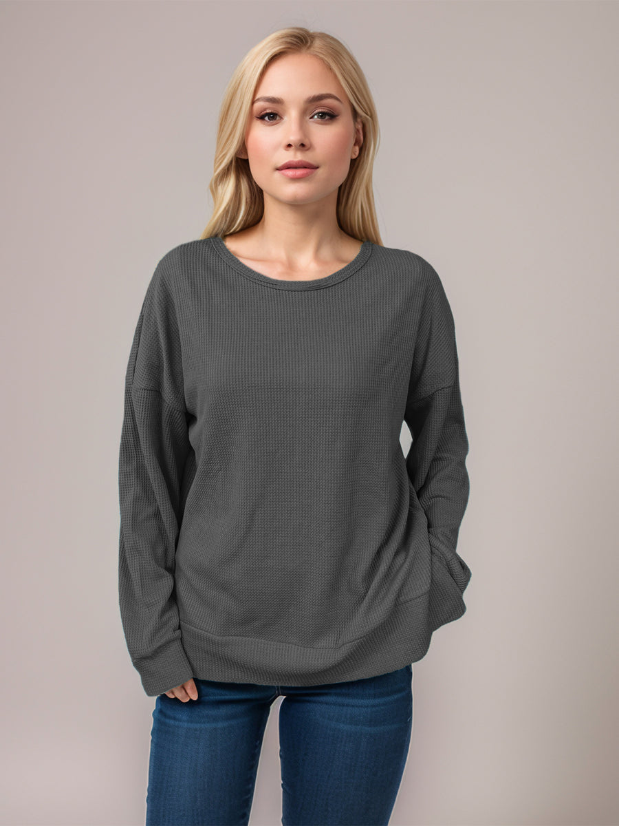 Dark Gray waffle knit relaxed fit crewneck top with long sleeves and a dropped shoulder.