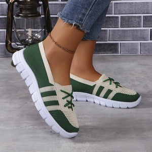 Breathable knit lace-up sneakers in dark green and beige with white soles.