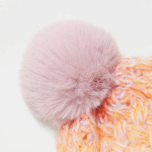 Textured ombre knit beanie in pink and orange with a fluffy pink pom detail.