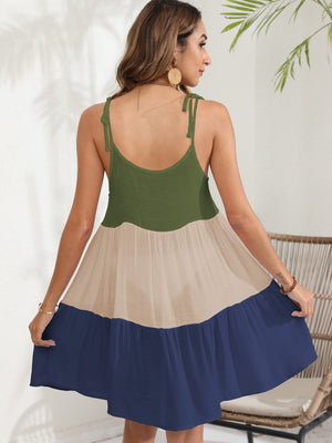 Tiered dress with tie straps in green, beige, and dark blue colorblock.
