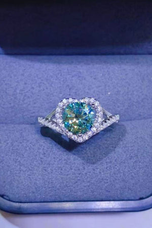 Silver engagement ring with a green heart halo moissanite center stone and diamond accents.