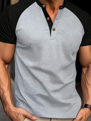 Contrast raglan henley polo shirt in gray with black sleeves and button placket.