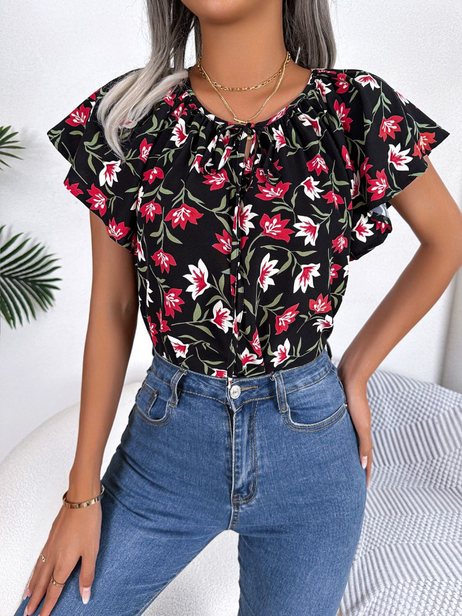 Black floral ruffle sleeve tie-neck blouse with red and white flowers